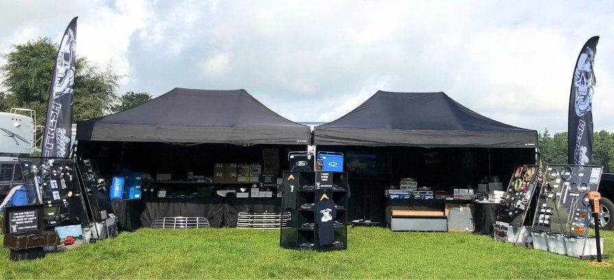 Pop Up Gazebo at Outdoor Event Pop up gazebo with printed flags at outdoor event